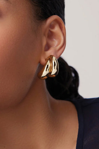 Jenny Bird Orla Earrings in 14K gold-dipped brass, featuring a modern triple-strand sculptural hoop design. these lightweight, high-polish gold earrings add a bold yet sophisticated finish to any professional or evening outfit.