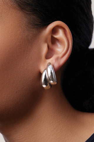Jenny Bird Orla Earrings in Sterling Silver-dipped brass, featuring a modern triple-strand sculptural hoop design. these lightweight, high-polish silver earrings add a bold yet sophisticated finish to any professional or evening outfit.