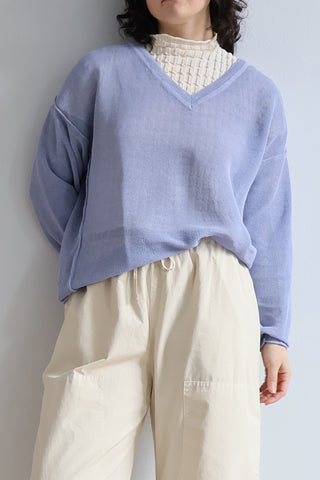 RUS Matsu Sweater in Salvia Blue, a boxy V-neck mesh sweater crafted from a premium corded organic cotton blend with a unique dry handfeel. This lightweight, breathable designer pullover features a relaxed silhouette and deep ribbed detailing, making it an effortless layering piece for modern, elevated everyday style.