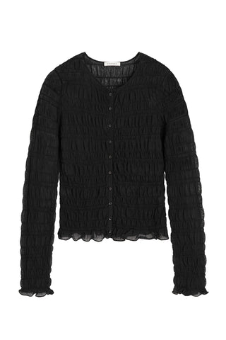 By Malene Birger Ebba Cardigan in black, featuring a unique smocked and puckered elasticated finish with delicate ruffle trim. This sheer, lightweight long-sleeve top offers a slim fit and feminine texture for transitional layering.