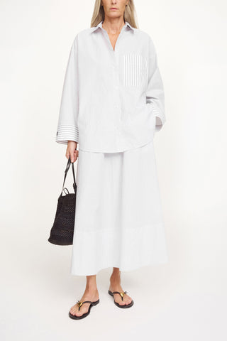 By Malene Birger Derris Shirt in a timeless black and white stripe, crafted from 100% organic cotton. This oversized button-down features a smart collar and a front patch pocket, offering a refined Scandinavian aesthetic for any season.