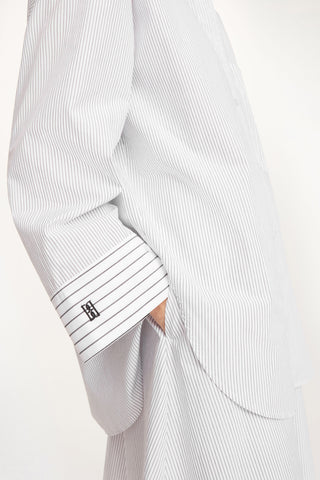 By Malene Birger Derris Shirt in a timeless black and white stripe, crafted from 100% organic cotton. This oversized button-down features a smart collar and a front patch pocket, offering a refined Scandinavian aesthetic for any season.