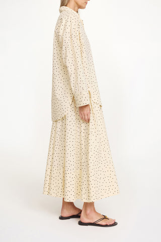 By Malene Birger Derris Shirt in Black and White Polkadot Print crafted from lightweight organic cotton voile. This oversized button down features a classic collar and front patch pocket for a timeless, airy silhouette. 