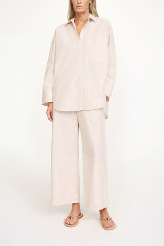 By Malene Birger Derris Shirt in Dark Sand Stripe, featuring a neutral brown and beige vertical pattern in 100% organic cotton. This oversized button-down includes a classic shirt collar and front patch pocket for an effortless Scandinavian look.