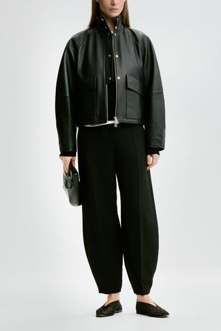 By Malene Birger premium leather oversized jacket, featuring a high funnel neck, silver snap buttons, and functional utility pockets.