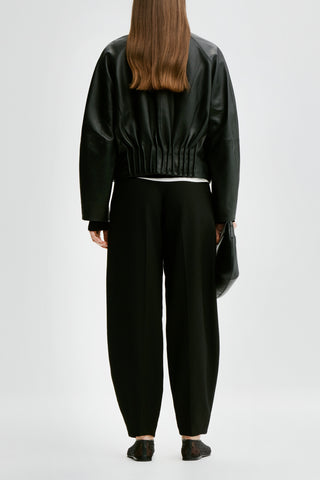 By Malene Birger premium leather oversized jacket, featuring a high funnel neck, silver snap buttons, and functional utility pockets.