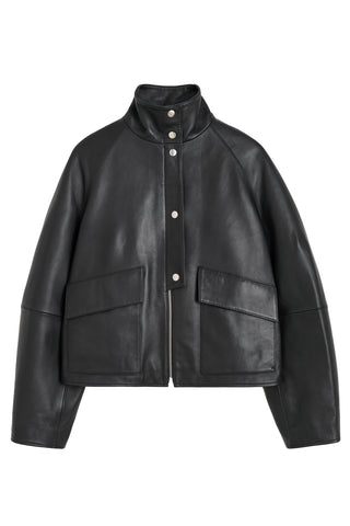 By Malene Birger premium leather oversized jacket, featuring a high funnel neck, silver snap buttons, and functional utility pockets.