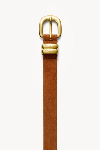 By Malene Birger Zoilo Suede Belt in Brown Patina, featuring buttery-soft cow leather and luxe rounded gold hardware. This adjustable brown suede belt adds rich texture and a polished finish to any high-waisted look.