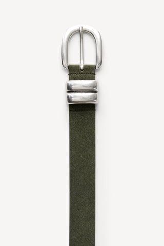 By Malene Birger Zoira Suede Belt in Deep Lichen Green, featuring a wide suede strap and a signature curved silver buckle. This adjustable one-size belt is designed to cinch the waist or sit on the hips for a sophisticated, textured look.