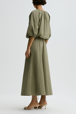 By Malene Birger Lelow Blouse in Deep Lichen Green, featuring a voluminous silhouette in crisp organic cotton. This versatile top includes an elasticated neckline for on or off-the-shoulder styling, with puff sleeves and an elasticated hem.