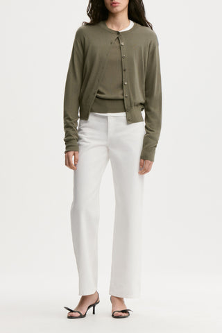 By Malene Birger Montie Cardigan in Deep Lichen Green, crafted from a premium wool and silk blend with Tencel fibers. This classic round-neck sweater features a button-down front and ribbed trims for a timeless, sophisticated silhouette.