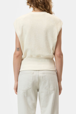 The Closed Sleeveless Crew in Beige is a premium knit top featuring a structured sleeveless design and a wide ribbed hem for a sophisticated, tapered fit. This versatile neutral vest is crafted from high-quality materials, making it an essential layering piece for contemporary minimalist wardrobes.