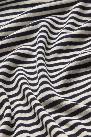 Frame Striped Knit Sweater in Cream Multi featuring soft bubble sleeves, a blouson silhouette, and classic navy horizontal stripes. This luxurious cotton-modal blend pullover is a versatile transitional piece perfect for effortless, coastal-inspired styling.