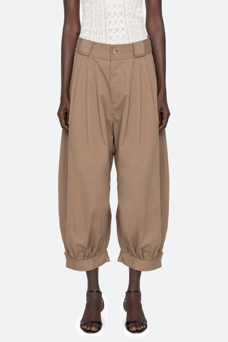 Sea New York Lois Twill Pants in Taupe are mid-waist and feature front pleats and wide belt loops. Balloon leg silhouette with snap button closure at ankles. 