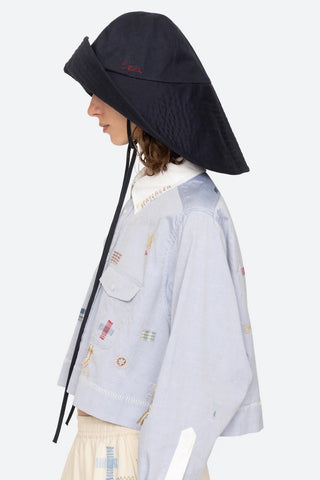 Sea New York Lois Twill Hat in Navy is a neutral toned hat featuring six panel construction and adjustable tie chin strap. Versatile spring and summer accessory.