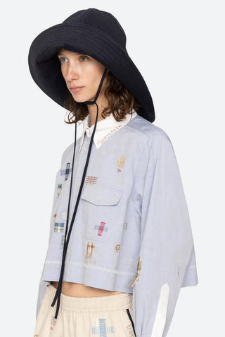 Sea New York Lois Twill Hat in Navy is a neutral toned hat featuring six panel construction and adjustable tie chin strap. Versatile spring and summer accessory.