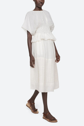 Sea New York Violet midi skirt in White featuring delicate pintuck detailing, an elasticized waistband, and a breezy A-line silhouette. This lightweight cotton skirt offers a relaxed fit, making it a perfect effortless piece for a fresh spring outfit.