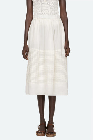 Sea New York Violet midi skirt in White featuring delicate pintuck detailing, an elasticized waistband, and a breezy A-line silhouette. This lightweight cotton skirt offers a relaxed fit, making it a perfect effortless piece for a fresh spring outfit.