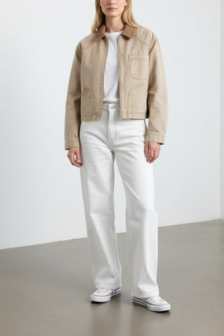 The SLVRLAKE Harley Crop Worker Jacket in Rocky Mountain is a premium cotton canvas utility jacket featuring a cropped silhouette and a contrasting brown corduroy collar. This designer workwear-inspired piece includes functional chest pockets and a zip-front closure, making it a rugged yet refined layer for transitional weather styling.