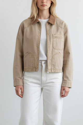 The SLVRLAKE Harley Crop Worker Jacket in Rocky Mountain is a premium cotton canvas utility jacket featuring a cropped silhouette and a contrasting brown corduroy collar. This designer workwear-inspired piece includes functional chest pockets and a zip-front closure, making it a rugged yet refined layer for transitional weather styling.