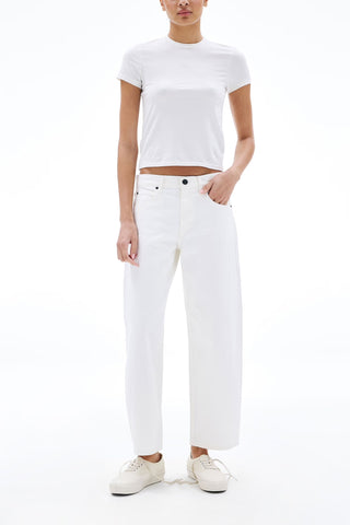 The SLVRLAKE Jamie Ankle Curve in White are mid-waist, designer jean featuring a unique curved leg silhouette and a cropped ankle length. Crafted from premium white denim, these stylish trousers offer a contemporary fit with a classic five-pocket construction for a clean, sophisticated look.