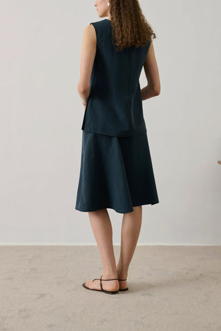 Soeur Gali Skirt in Petrole, a sophisticated midi-length A-line skirt crafted from a premium wool blend in a deep teal-blue hue. This elegant designer skirt features a clean waistline and a fluid drape, offering a polished silhouette that pairs perfectly with slim knits or a crisp button-down.