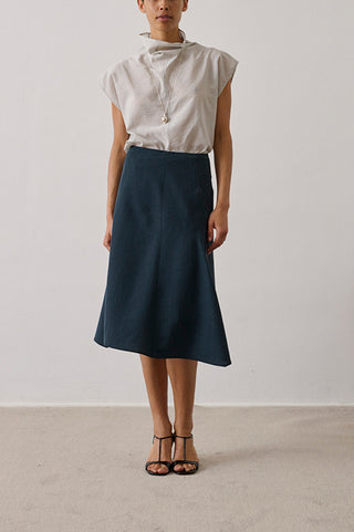Soeur Gali Skirt in Petrole, a sophisticated midi-length A-line skirt crafted from a premium wool blend in a deep teal-blue hue. This elegant designer skirt features a clean waistline and a fluid drape, offering a polished silhouette that pairs perfectly with slim knits or a crisp button-down.