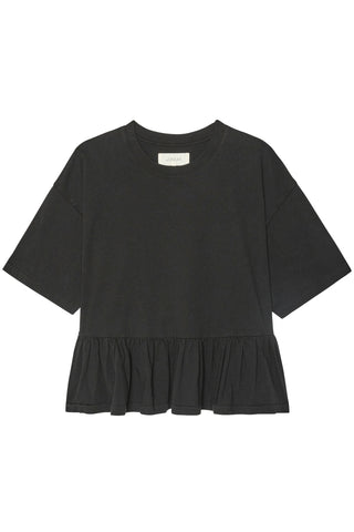 The Great Oversized Ruffle Peplum Tee in True Black, a comfortable boxy cotton t-shirt with a feminine tiered hem. This versatile designer top pairs perfectly with denim for an elevated yet effortless look.